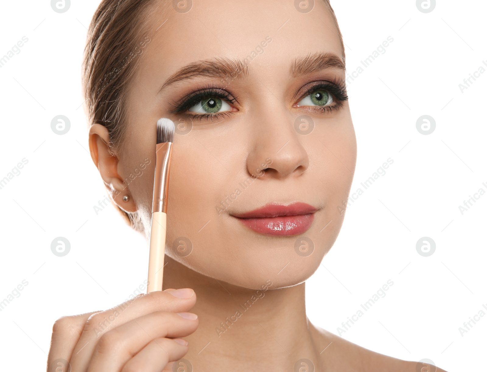 Photo of Beautiful woman applying makeup with brush on white background