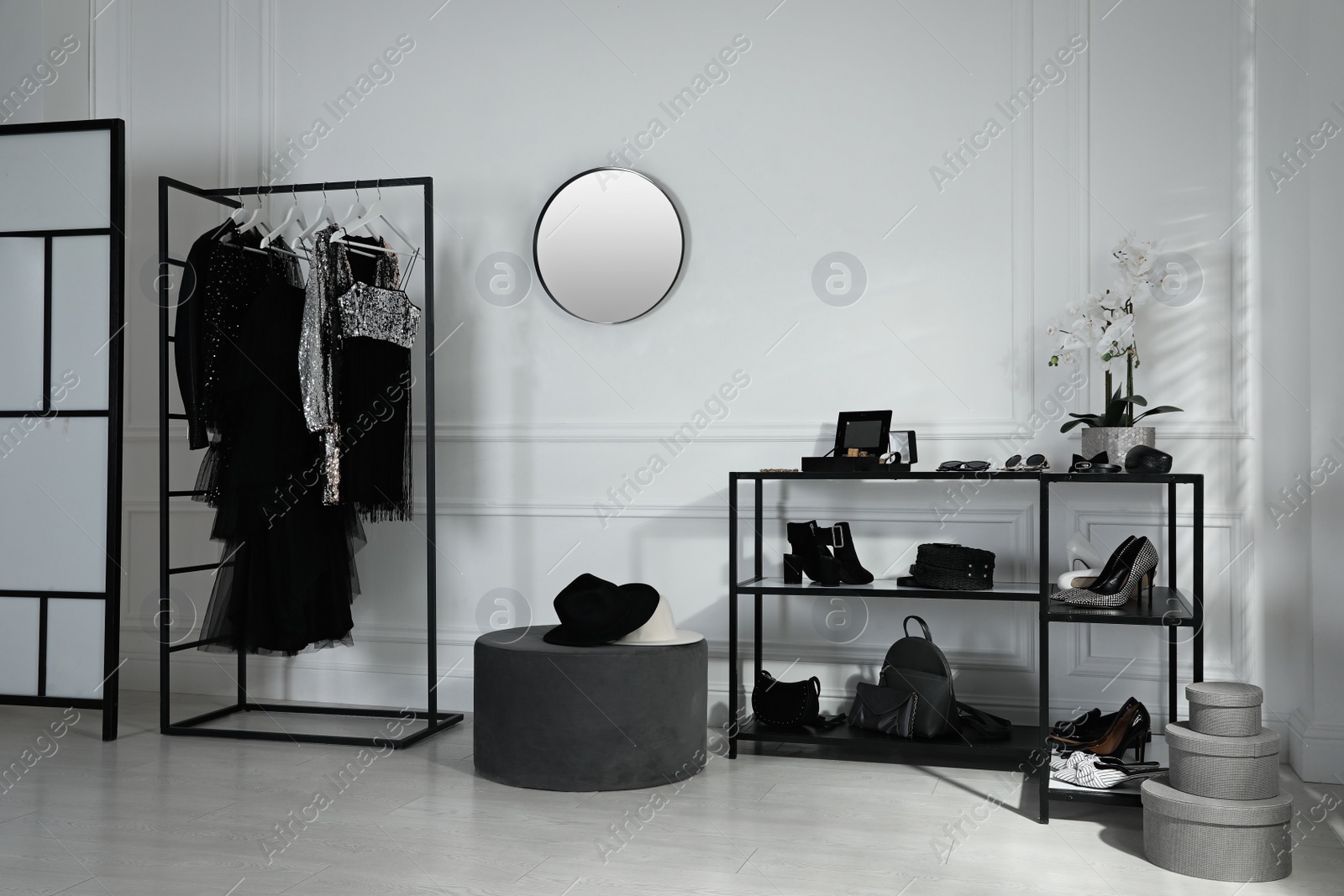 Photo of Stylish dressing room interior with trendy clothes, shoes and accessories