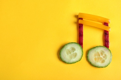 Photo of Musical note made of vegetables on color background, top view. Space for text