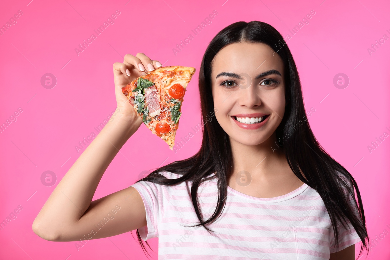 Photo of Beautiful woman eating pizza on pink background