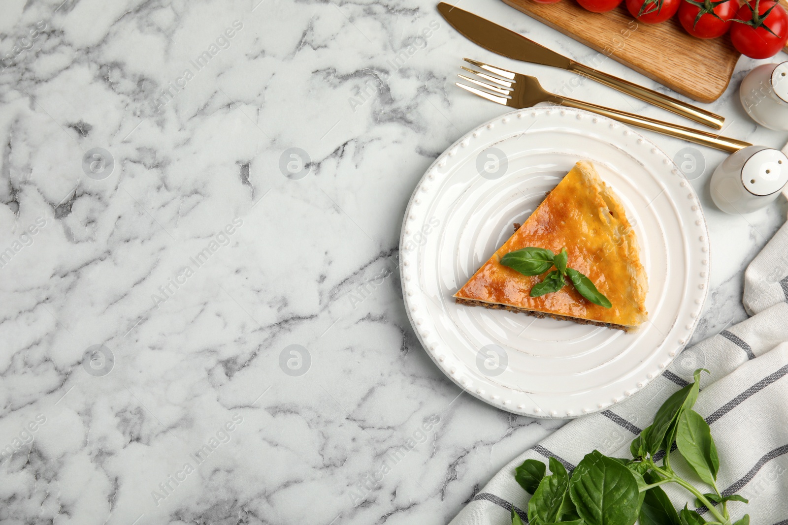 Photo of Piece of delicious pie with minced meat on white marble table, flat lay. Space for text