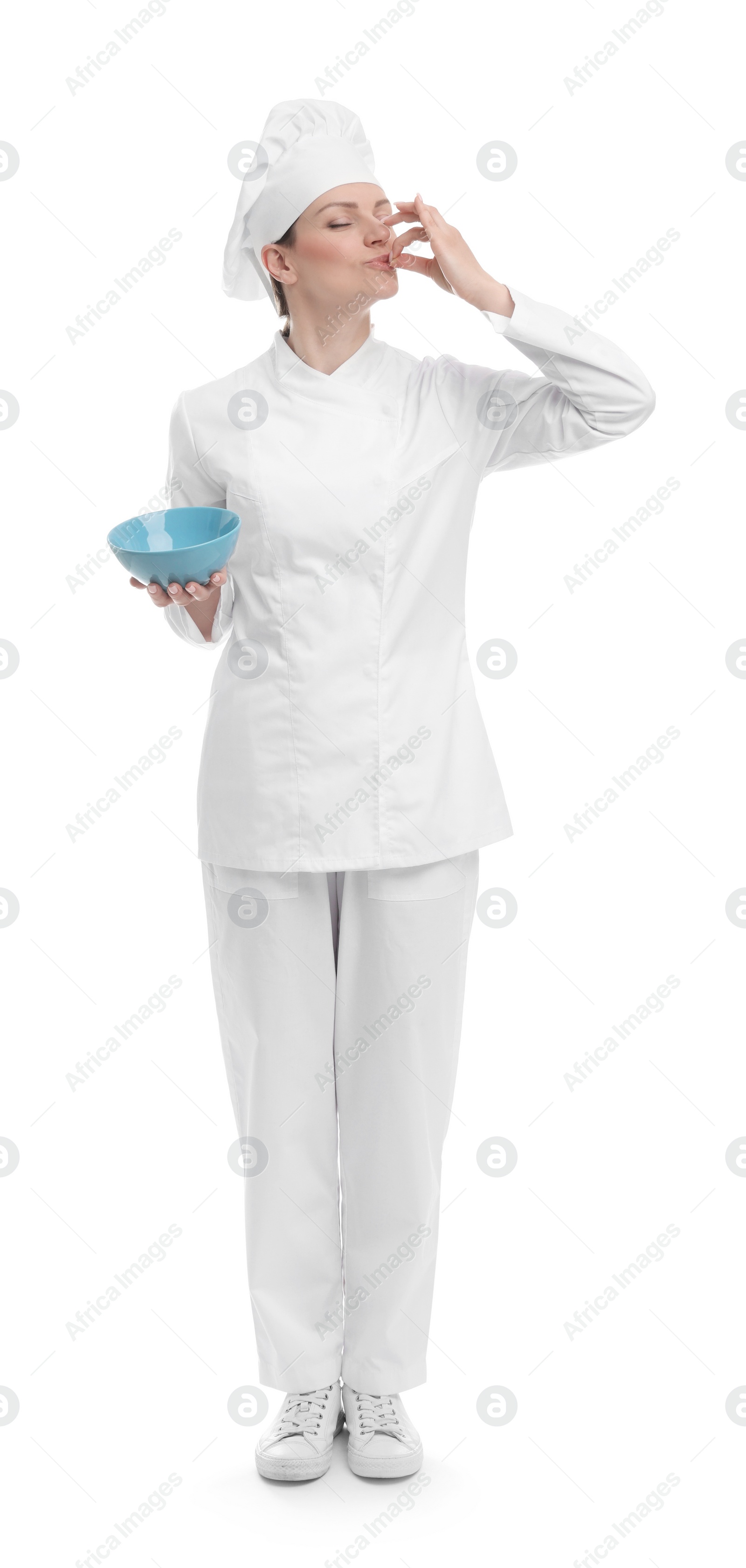 Photo of Woman chef in uniform holding bowl and showing perfect sign on white background