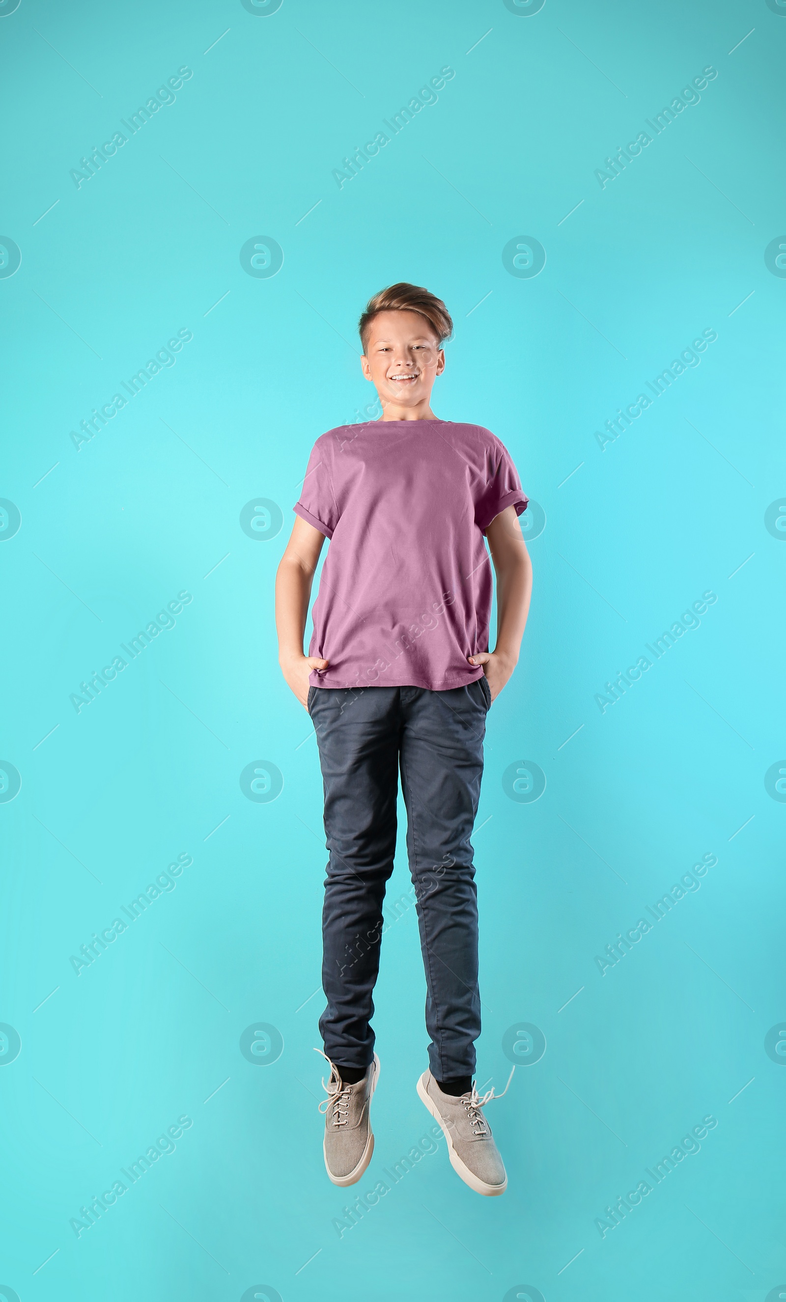 Photo of Teenage boy in casual clothes on color background