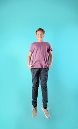 Photo of Teenage boy in casual clothes on color background