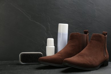 Stylish footwear with shoe care accessories on black table