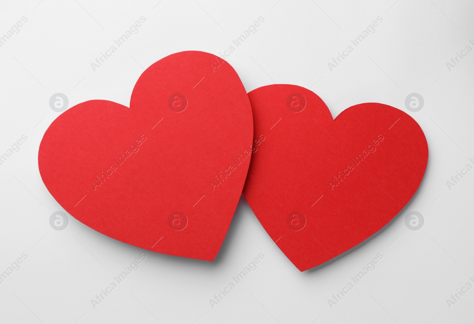 Photo of Paper hearts on white background, top view