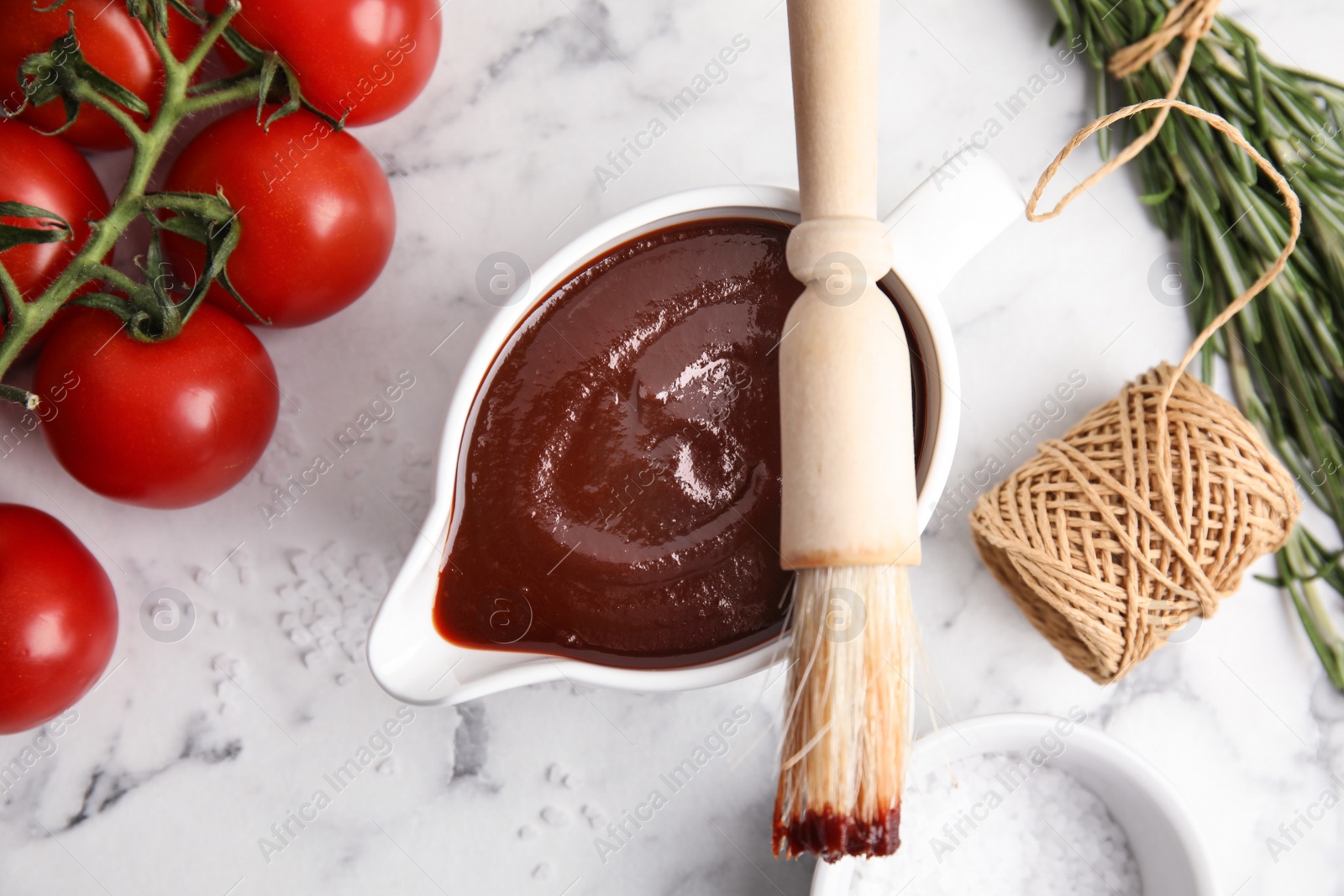 Photo of Flat lay composition with barbecue sauce on marble background