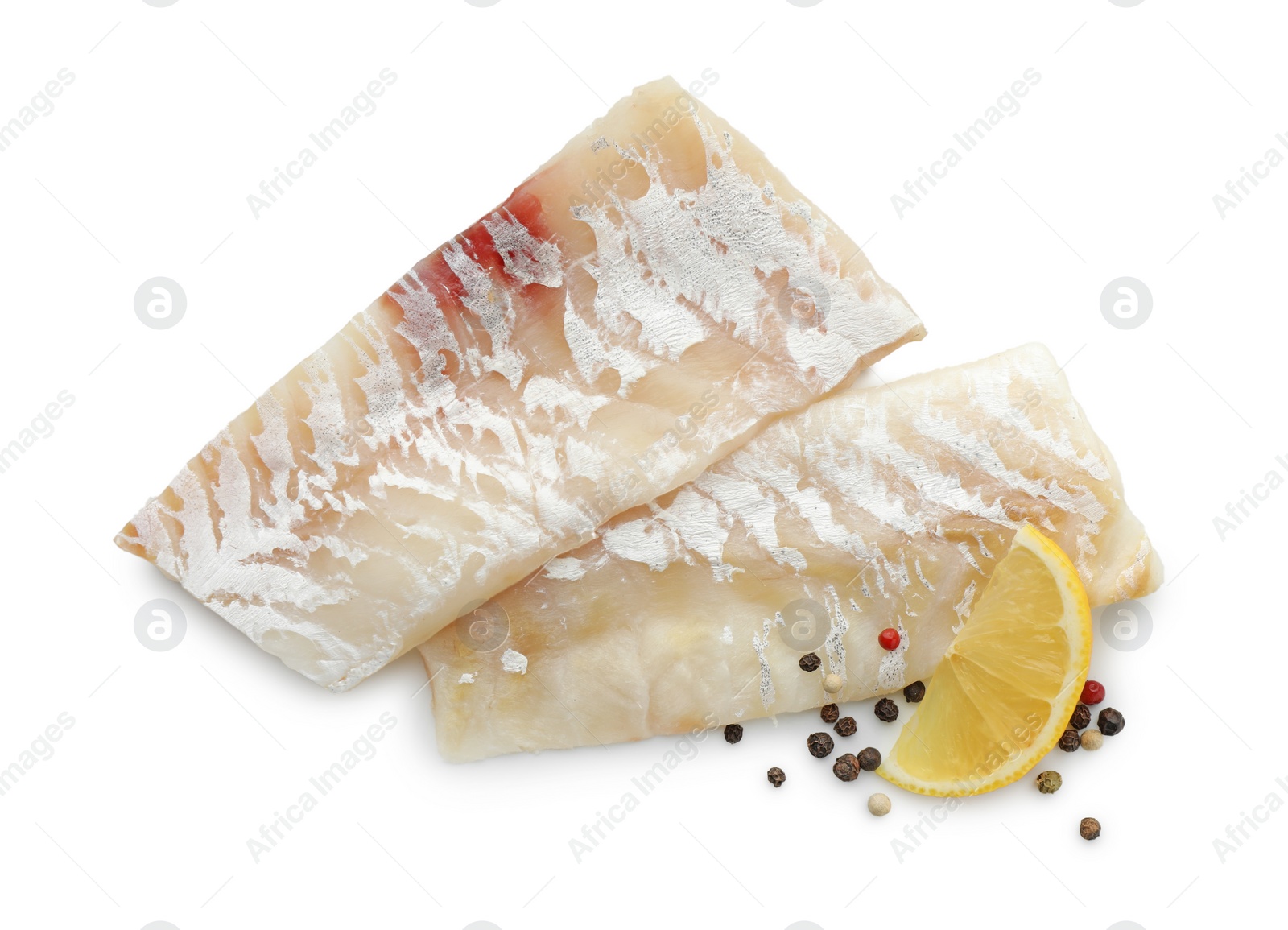 Photo of Fresh raw cod fillets with peppercorns and lemon isolated on white, top view