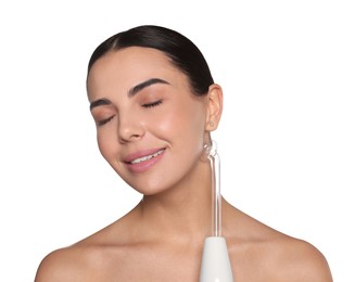 Woman using high frequency darsonval device on white background