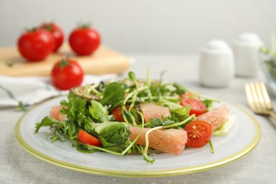 Photo of Delicious pomelo salad served on light grey table, closeup