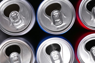 Photo of Energy drinks in cans as background, top view. Functional beverage