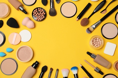 Photo of Flat lay composition with skin foundation, powder and beauty accessories on color background. Space for text