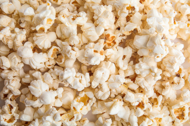 Photo of Tasty fresh pop corn as background, top view