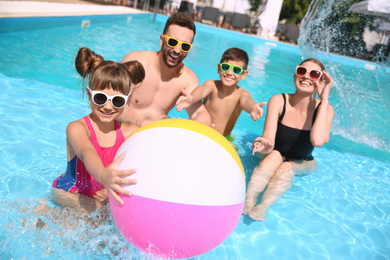 Photo of Happy family having fun in swimming pool