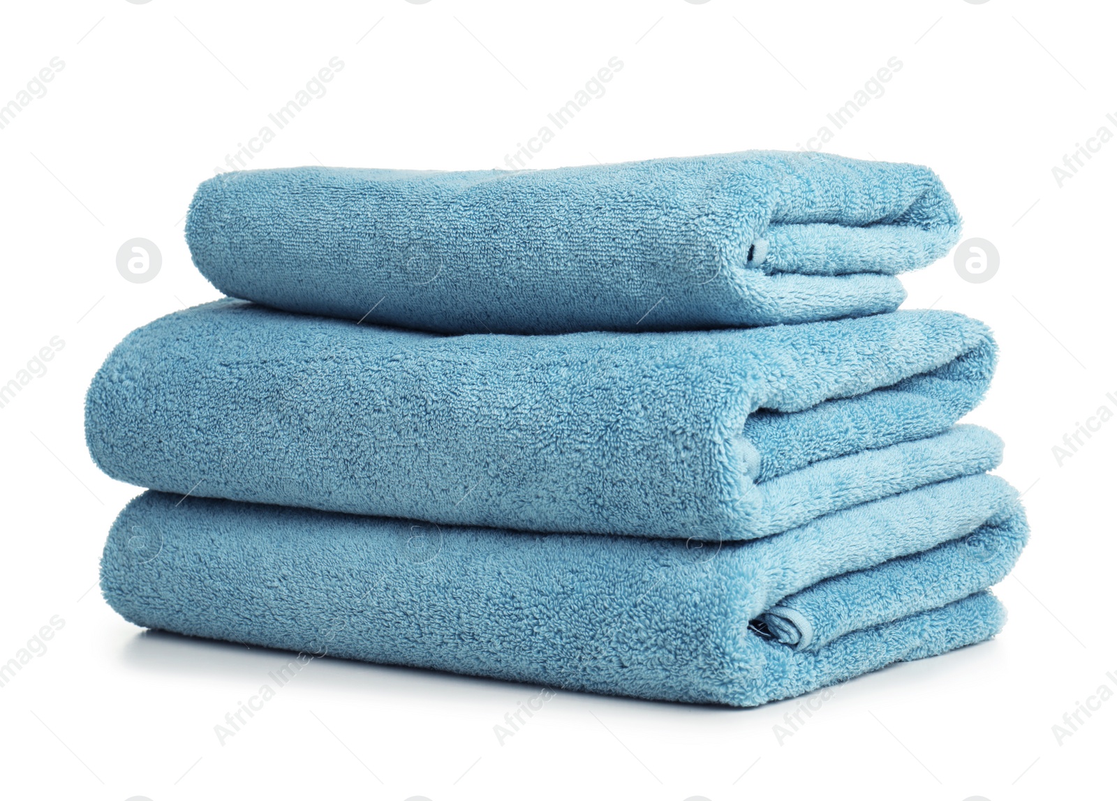 Photo of Folded soft terry towels on white background