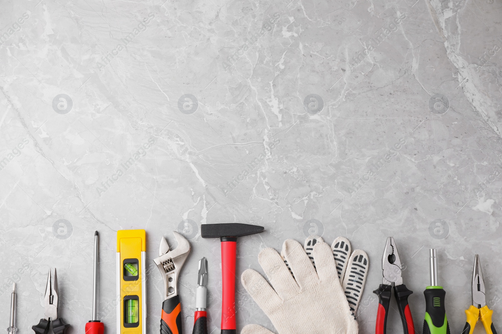 Photo of Flat lay composition with different construction tools on marble background. Space for text