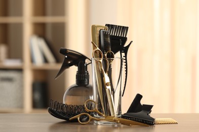 Photo of Set of hairdresser tools on table in salon