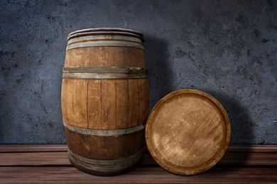 Image of Wooden barrels on surface near dark textured wall