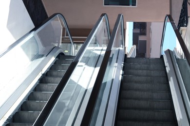 Photo of Modern escalators with handrails in shopping mall