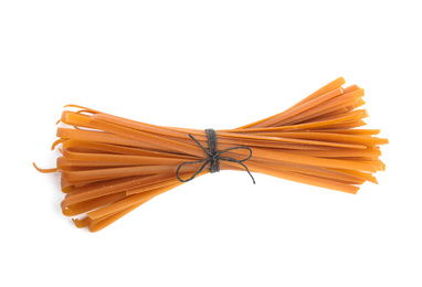 Uncooked buckwheat noodles isolated on white, top view