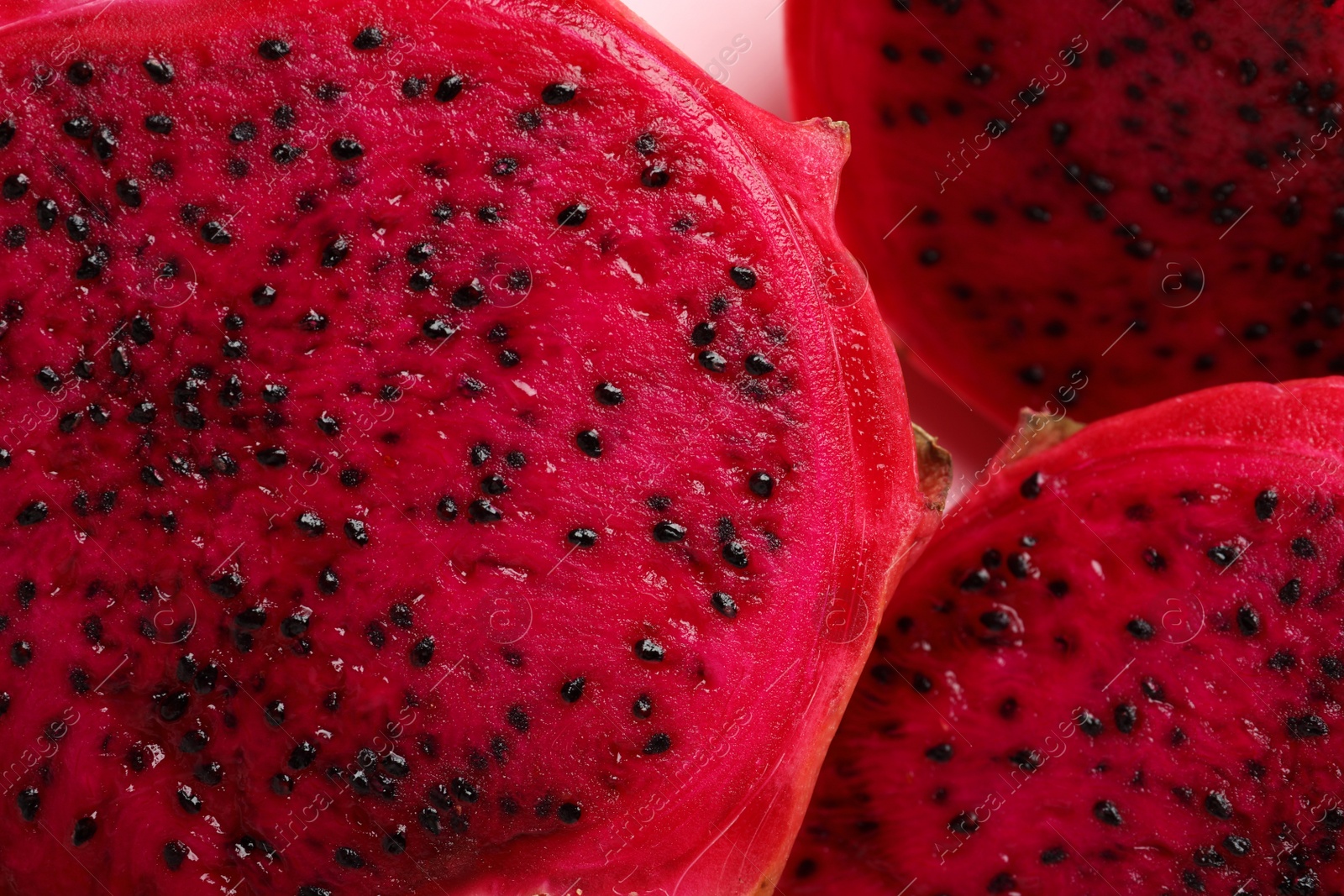 Photo of Delicious cut red pitahaya fruit, closeup view