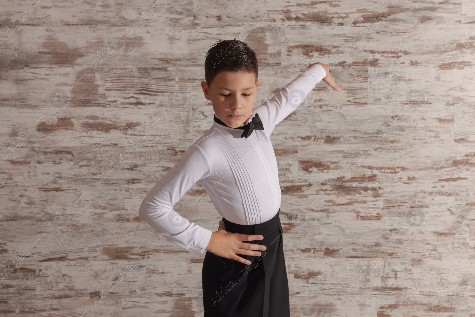 Photo of Beautifully dressed little boy dancing in studio