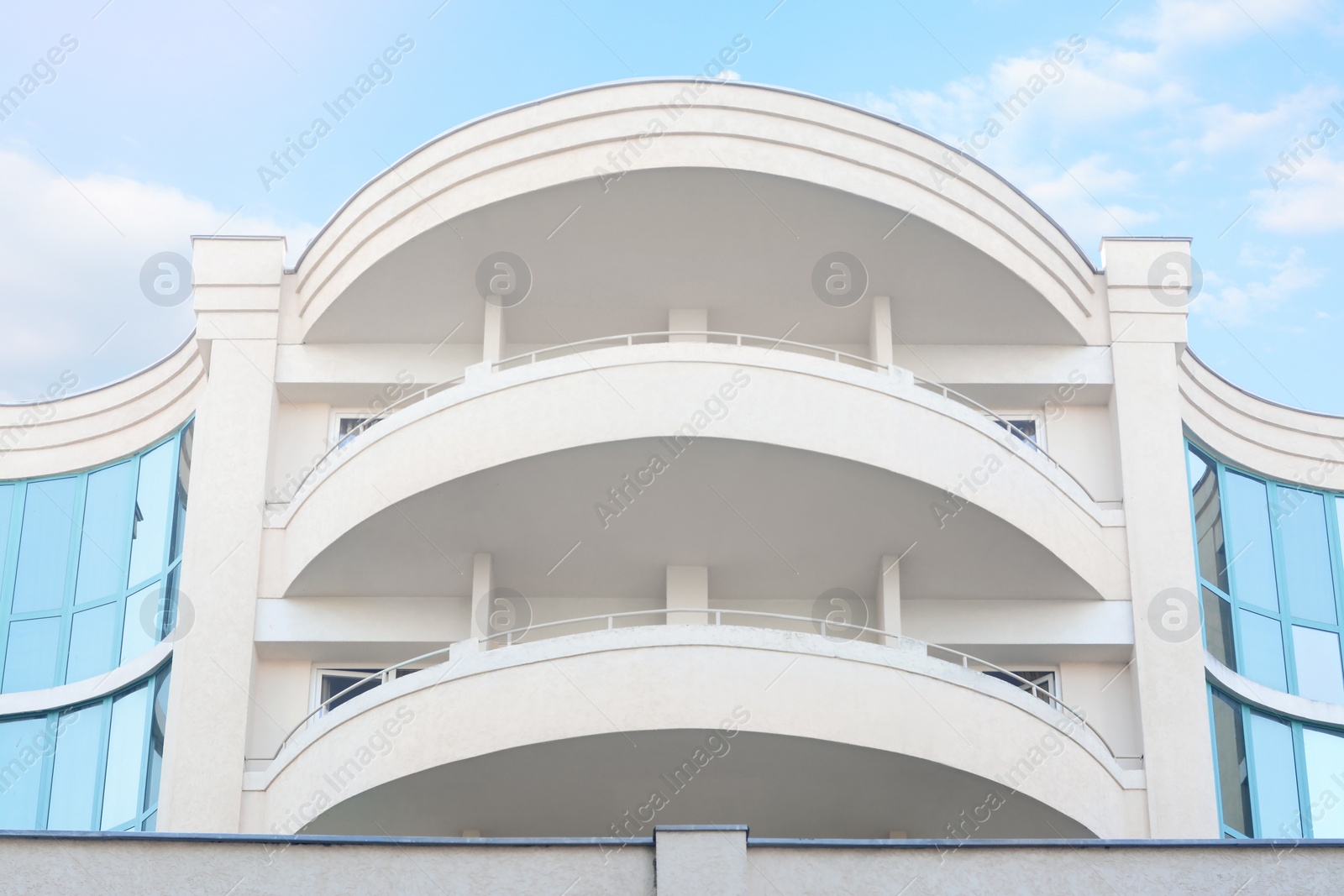 Photo of Exterior of beautiful residential building with balconies, low angle view