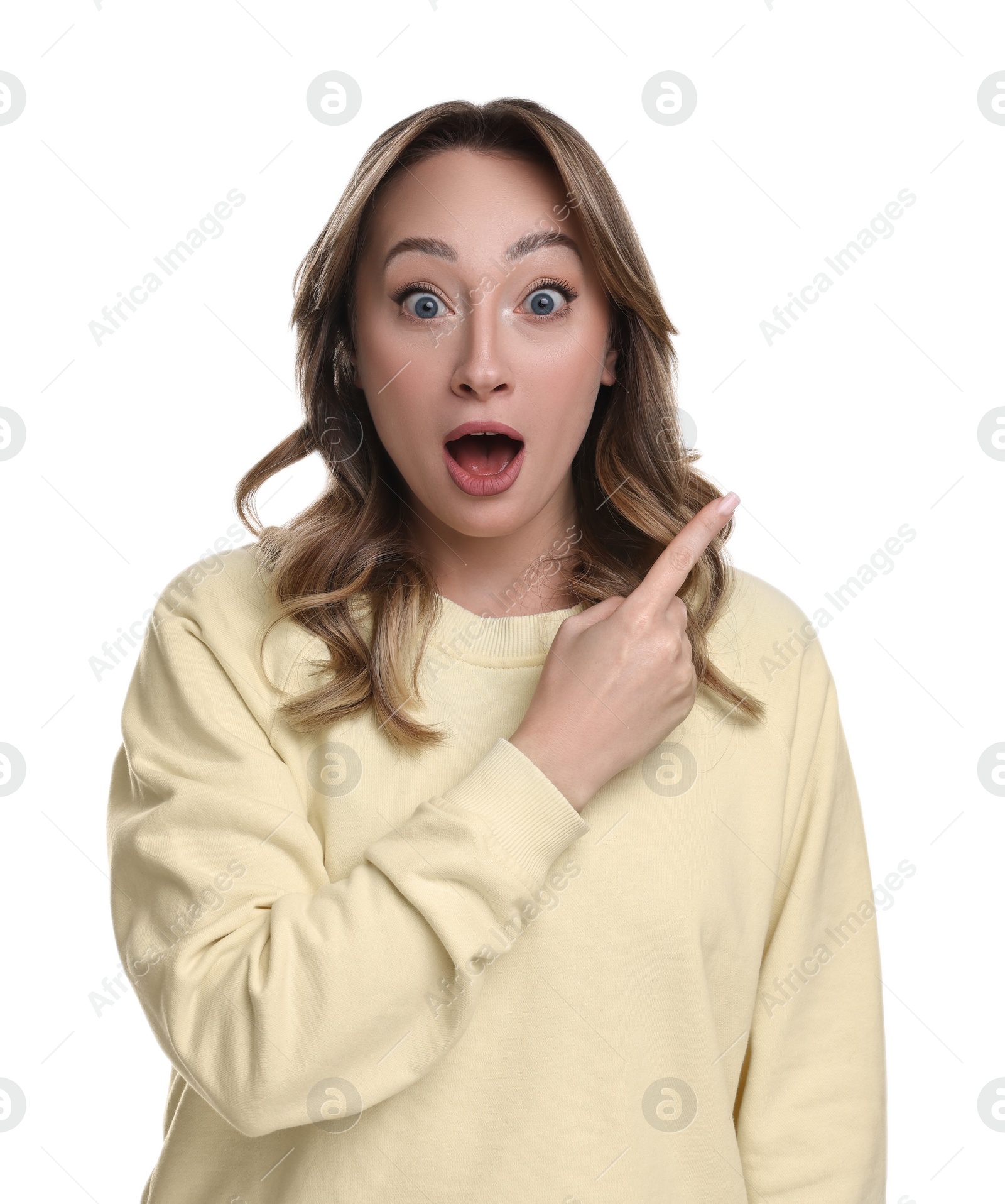 Photo of Portrait of surprised woman pointing at something on white background