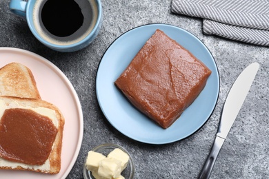 Photo of Quince paste with sandwich served for breakfast on grey table, flat lay