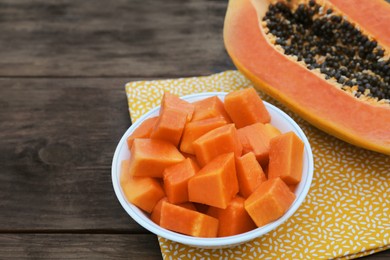 Tasty ripe cut papaya fruits on wooden table, closeup