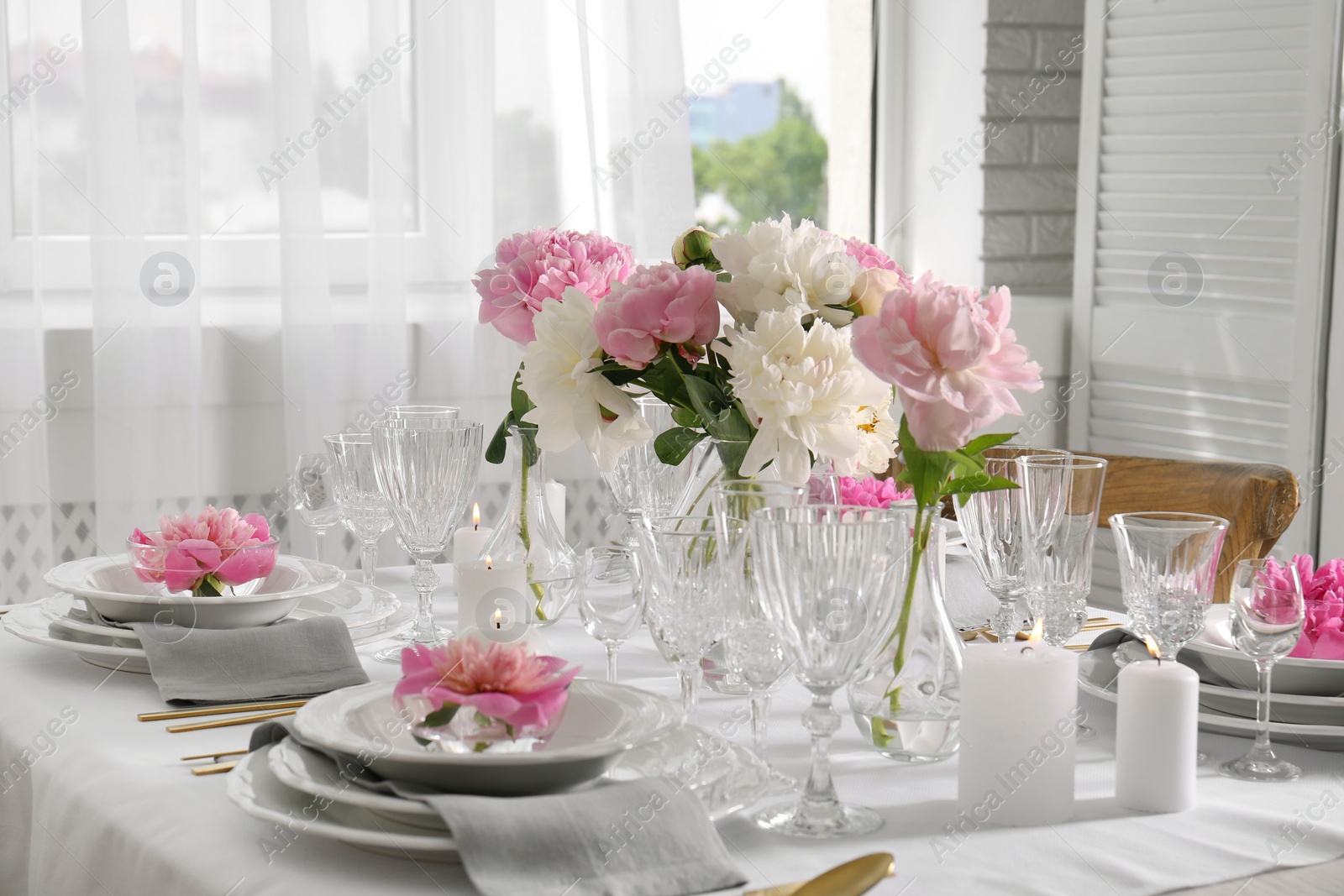 Photo of Stylish table setting with beautiful peonies in dining room