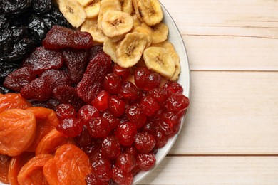 Delicious dried fruits on white wooden table, top view. Space for text