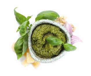 Photo of Fresh tasty pesto sauce and ingredients isolated on white, top view