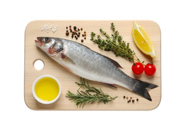 Board with fresh sea bass fish and ingredients on white background, top view