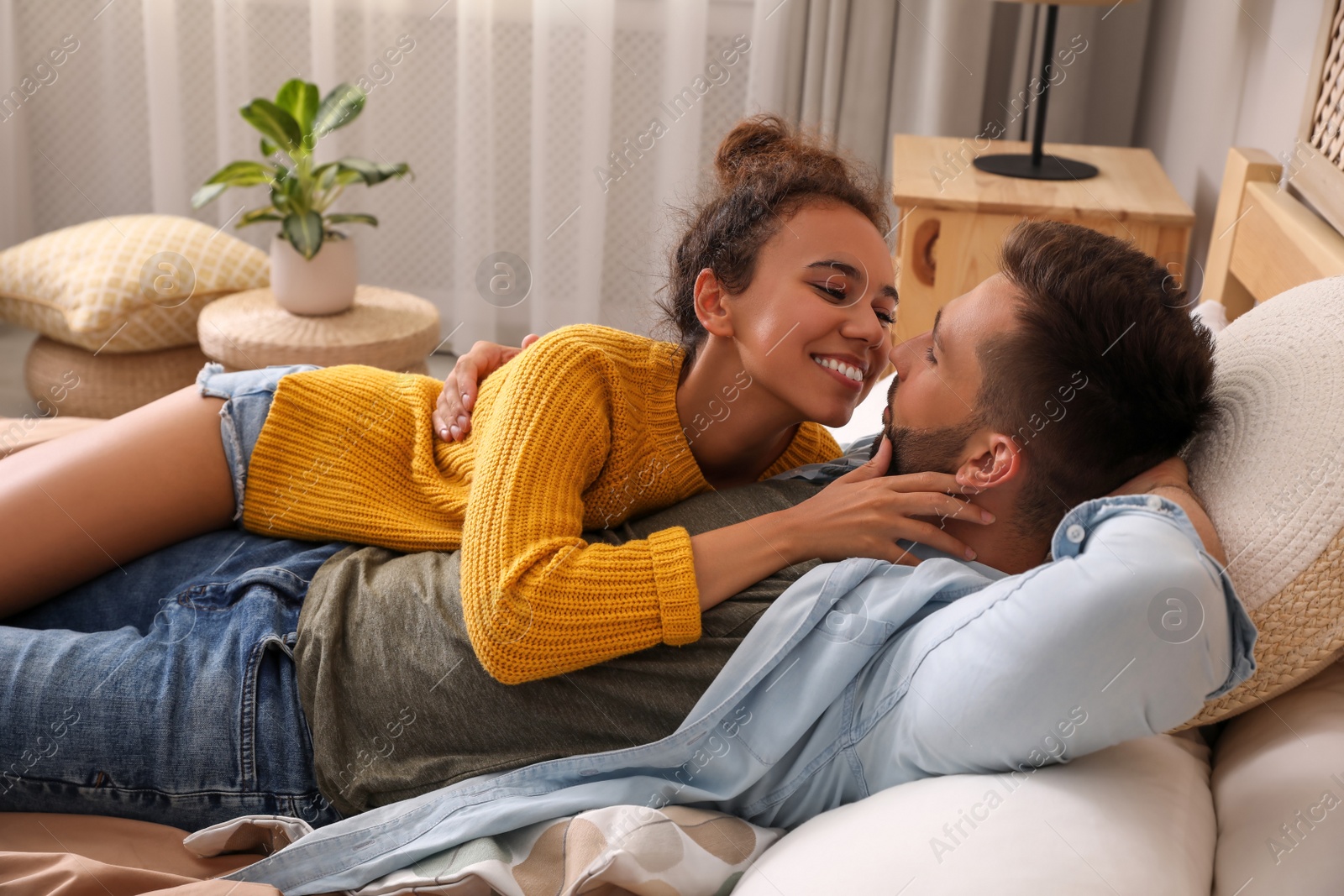 Photo of Lovely couple enjoying each other on bed at home