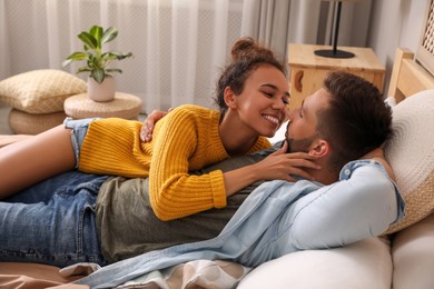Photo of Lovely couple enjoying each other on bed at home