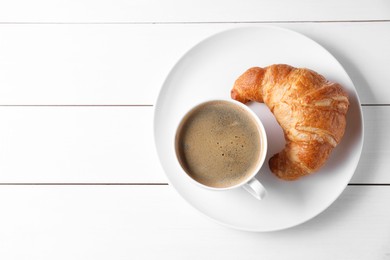 Photo of Breakfast time. Fresh croissant and coffee on white wooden table, top view. Space for text