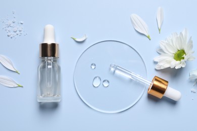 Photo of Bottle of cosmetic serum, pipette and flower on light blue background, flat lay