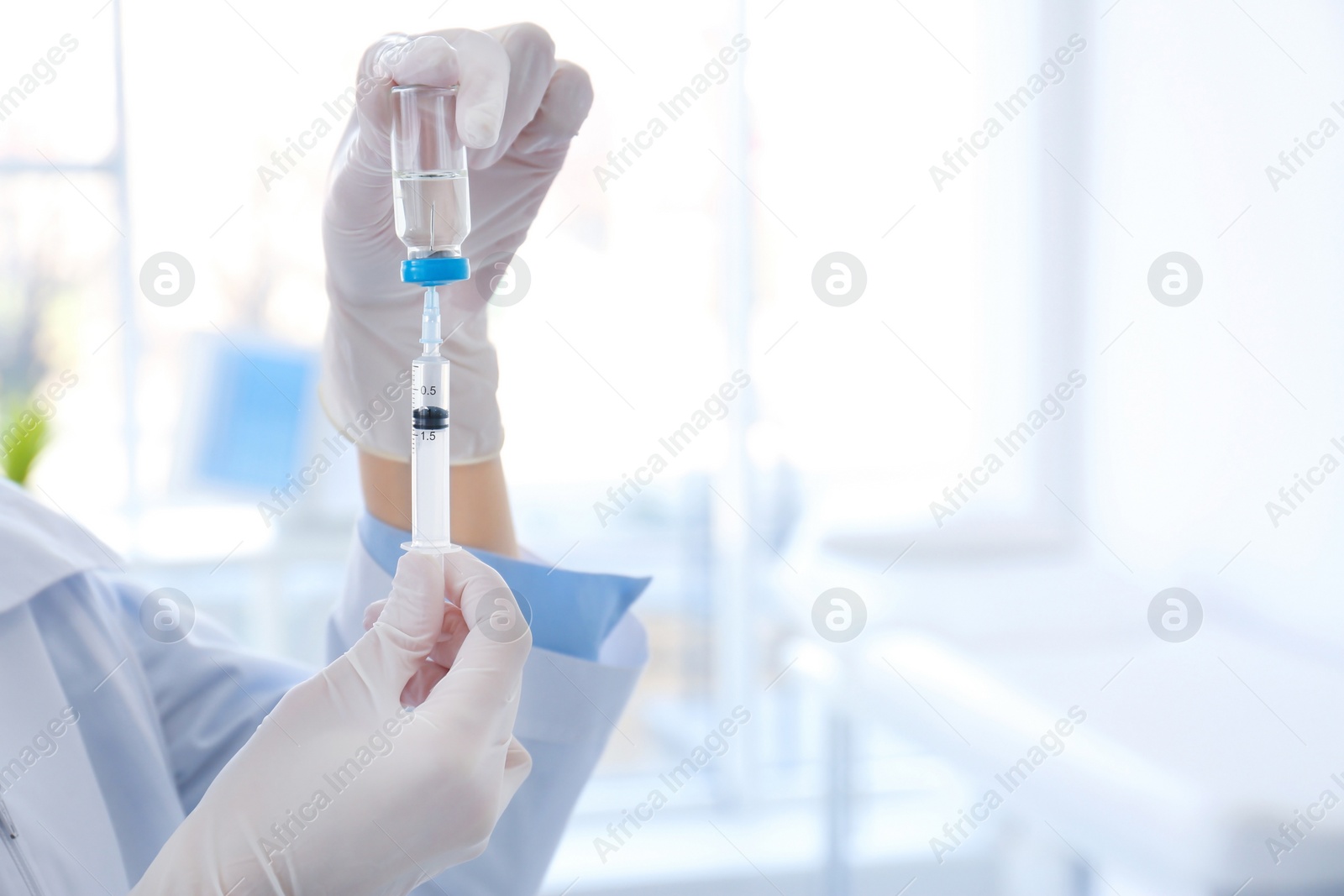 Photo of Female doctor with vial and syringe in hospital. Vaccination day