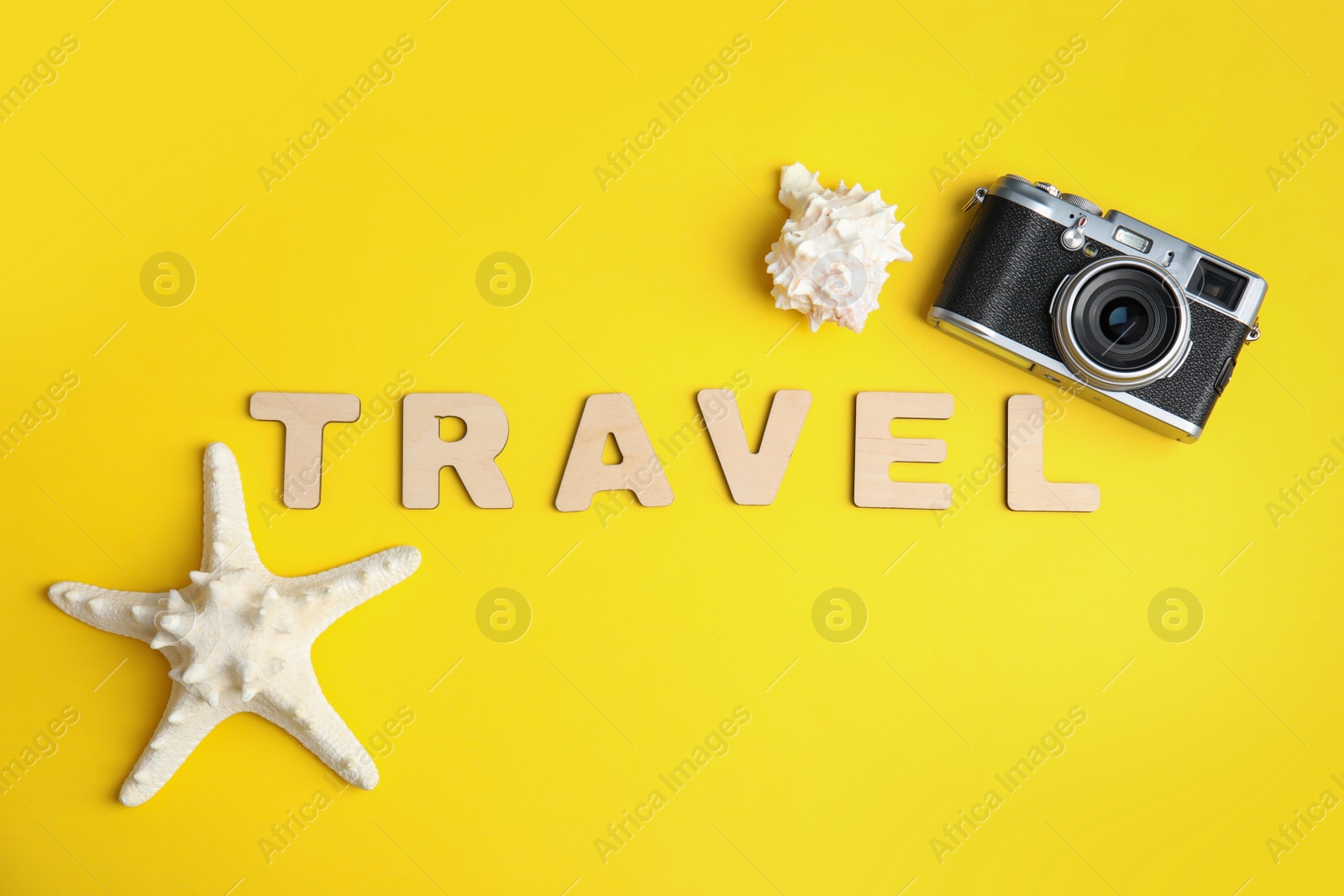 Photo of Flat lay composition with word TRAVEL and camera on color background. Tourist agency