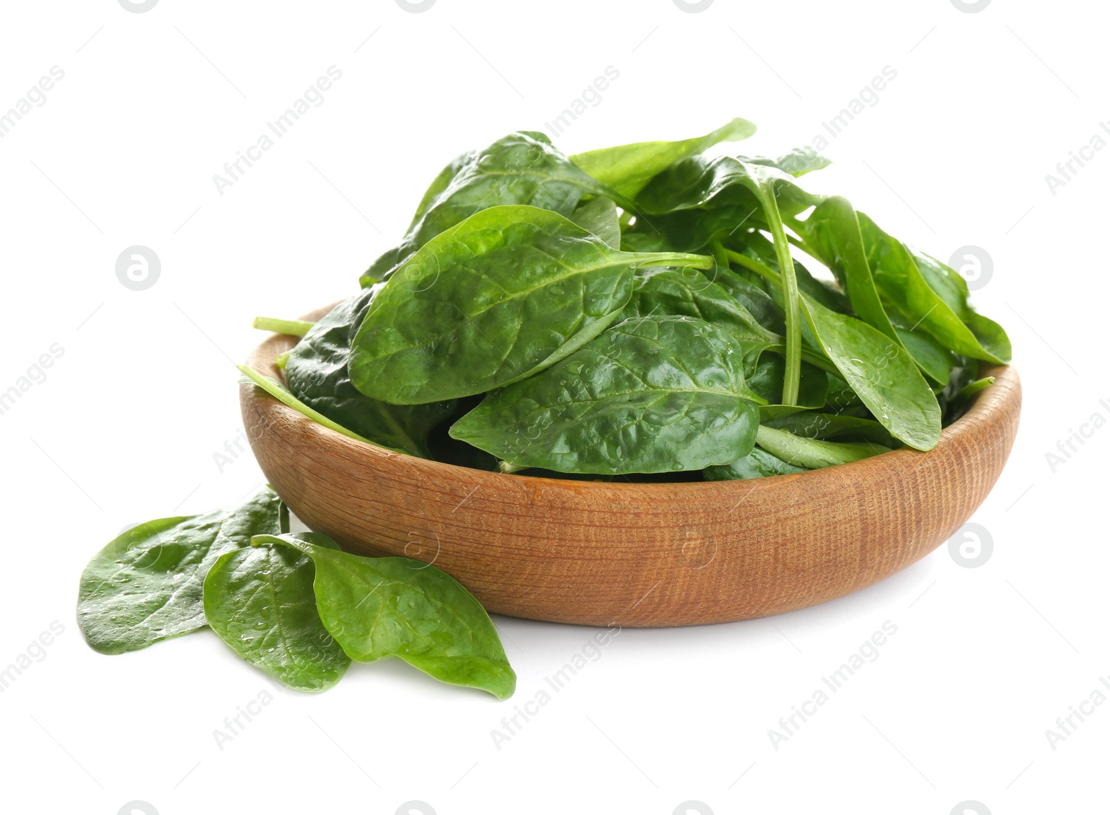 Photo of Fresh green healthy baby spinach leaves in wooden bowl isolated on white