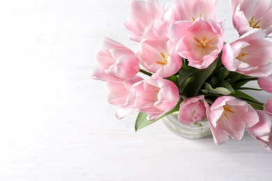 Beautiful tulips for Mother's Day on table, top view