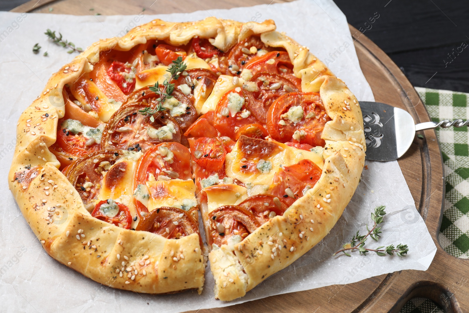 Photo of Tasty galette with tomato and cheese (Caprese galette) on table, closeup