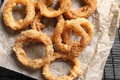 Photo of Cooling rack with homemade crunchy fried onion rings, top view