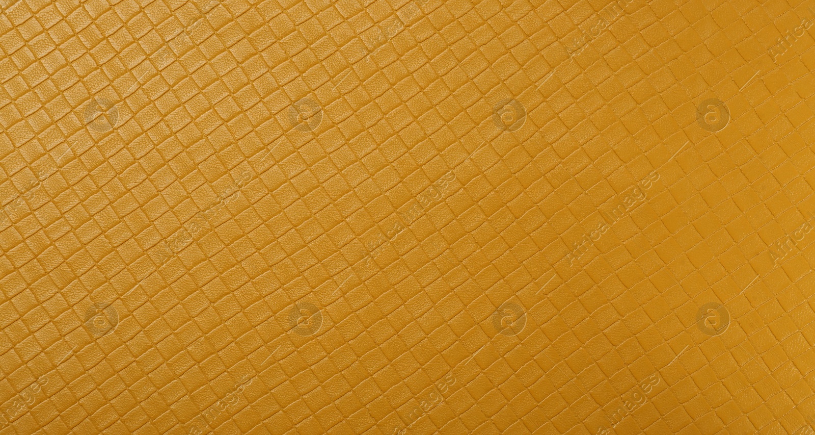 Photo of Beautiful yellow leather as background, top view