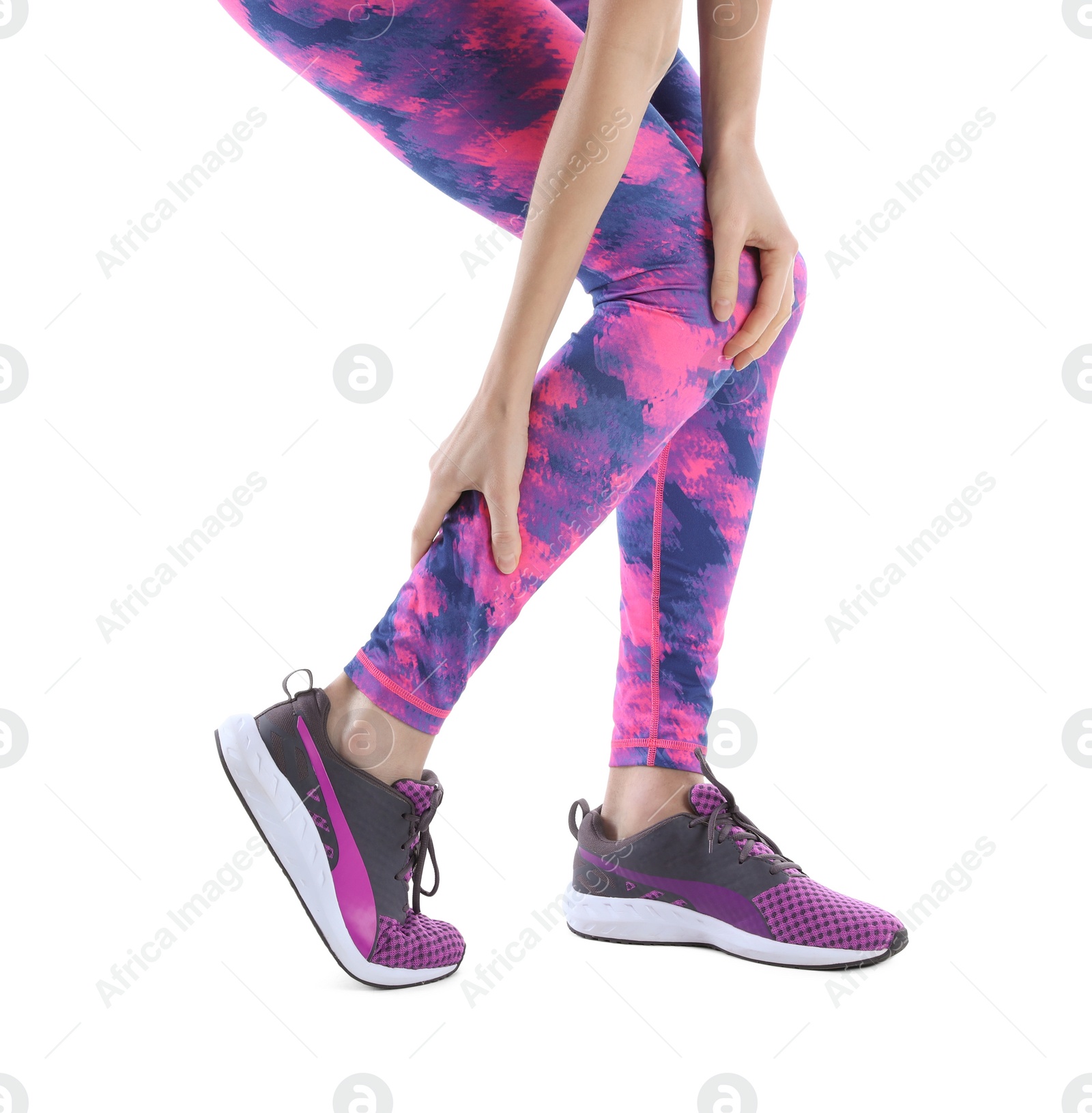 Photo of Young woman suffering from leg pain on white background, closeup
