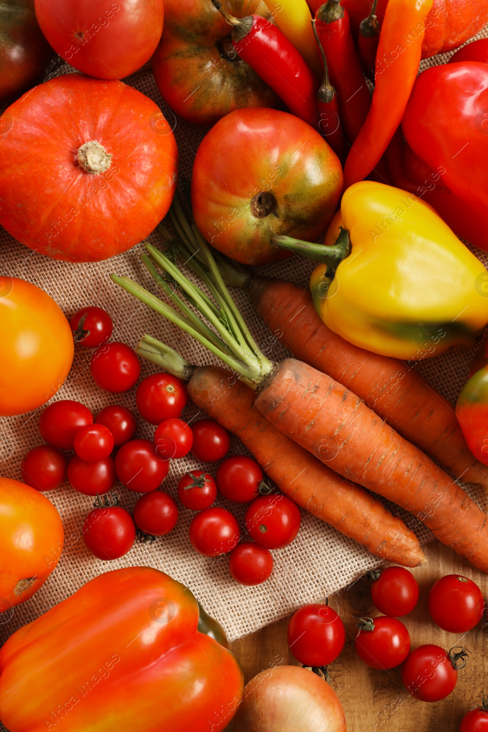 Photo of Different fresh ripe vegetables on wooden table, flat lay