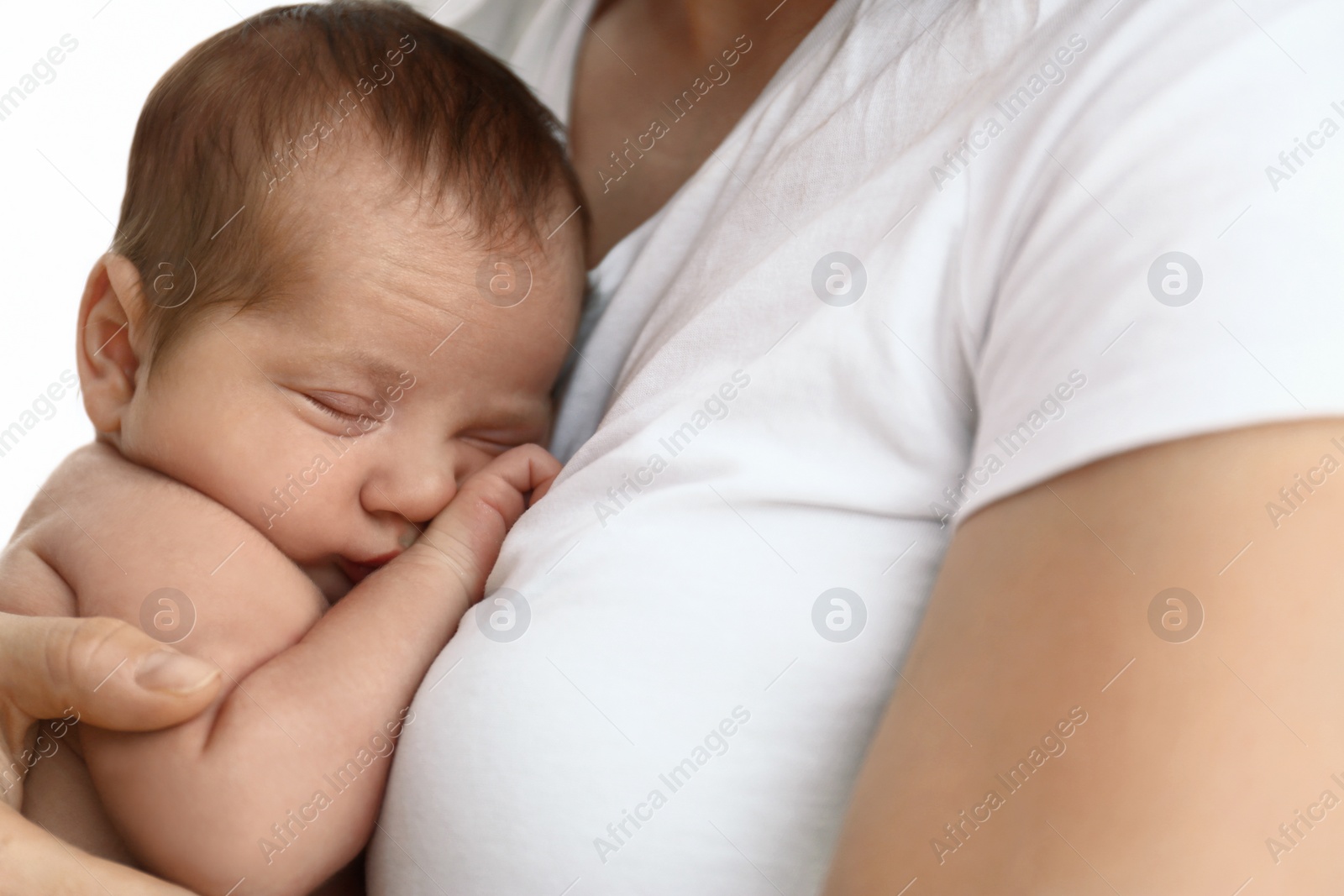 Photo of Young mother with her little baby on light background