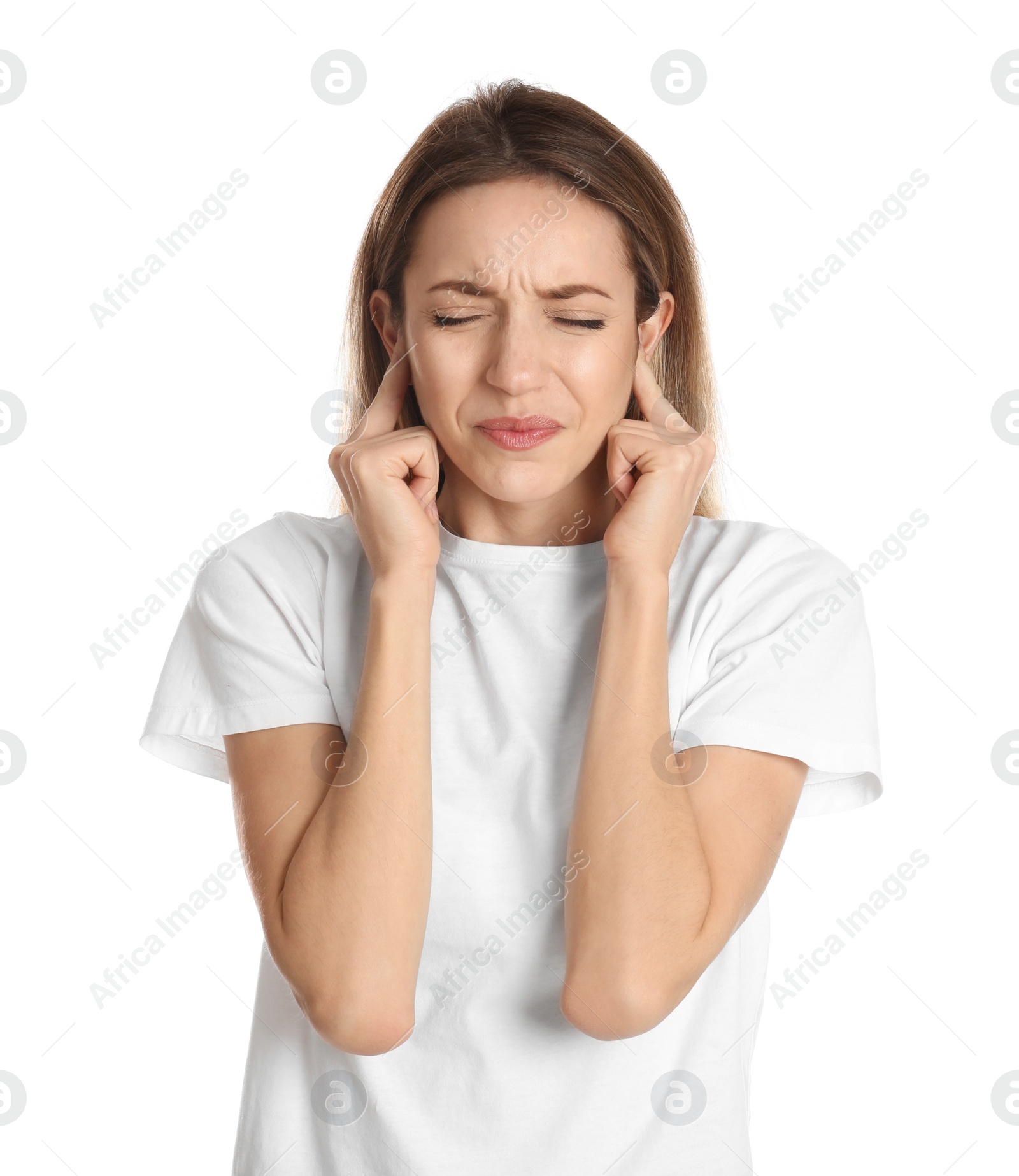 Photo of Emotional young woman covering her ears with fingers on white background