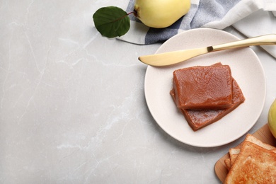 Photo of Delicious quince paste on white table, flat lay. Space for text